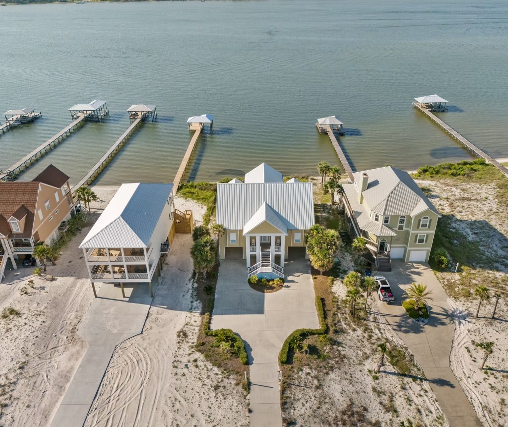 Aerial view of a coastal home with private docks on the water