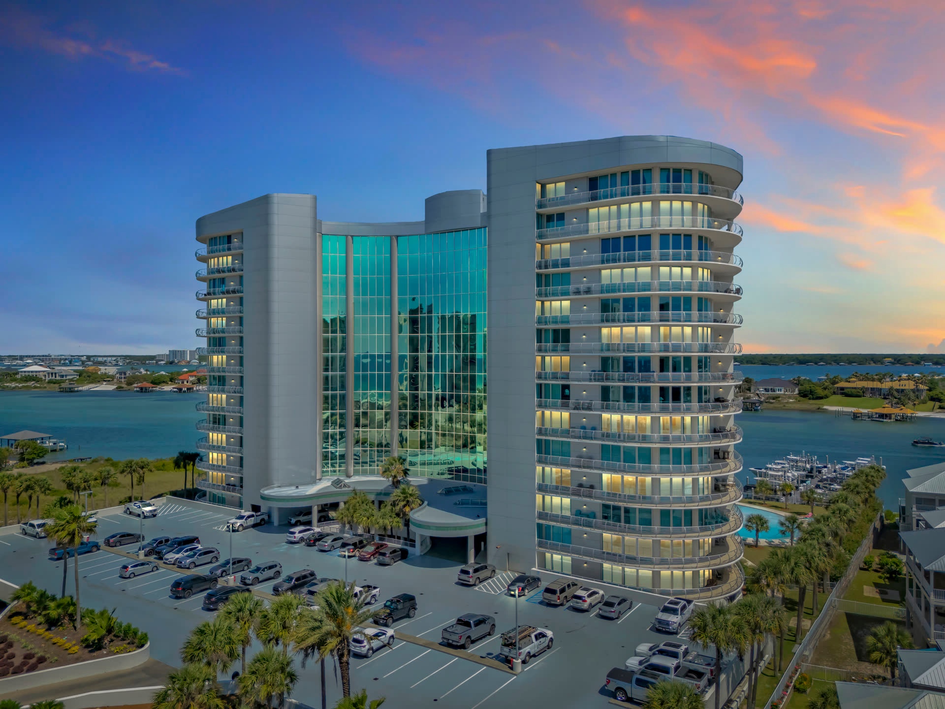 Aerial view of a waterfront residential building at sunset