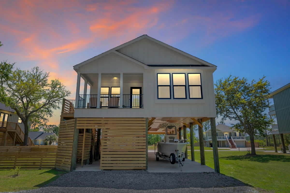 Elevated coastal beach house exterior at dusk