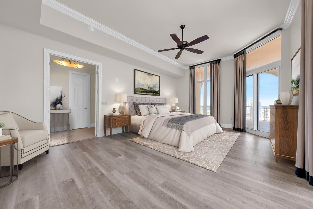Staged bedroom with wood floors and balcony access