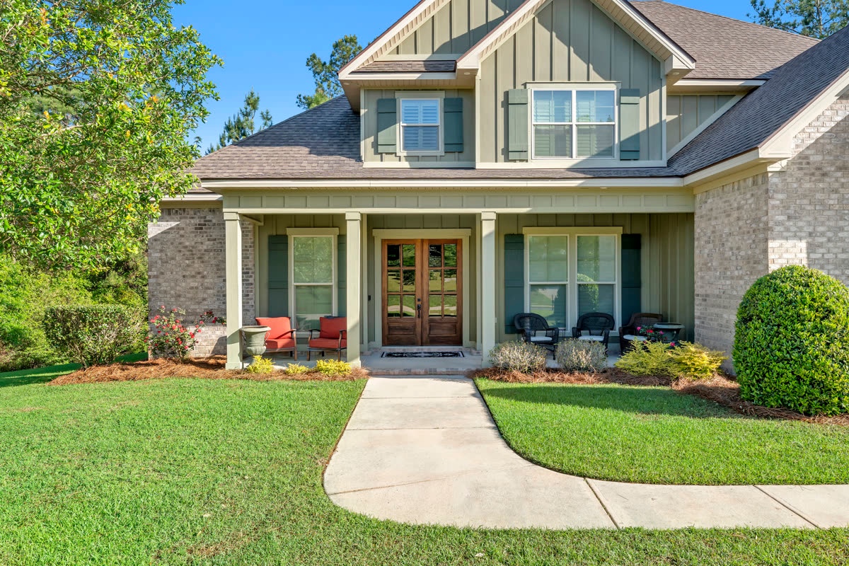Craftsman-style coastal home exterior with manicured landscaping