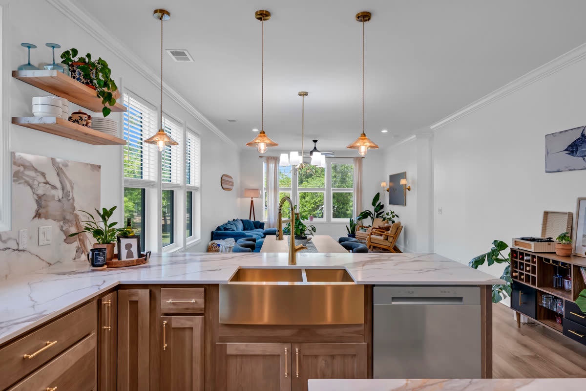 Bright kitchen with a center island, wood cabinetry, and pendant lighting