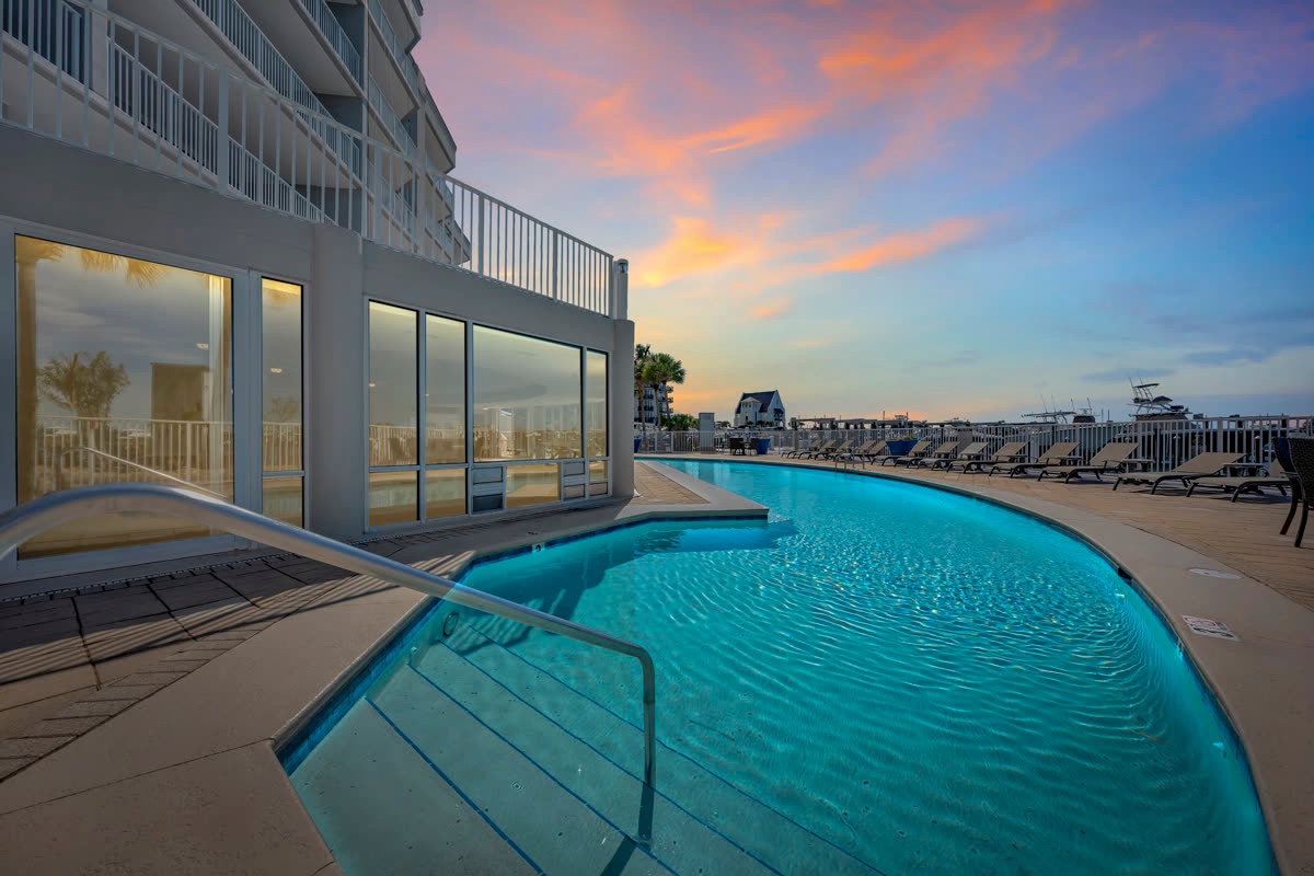Rooftop terrace pool overlooking the beach at twilight